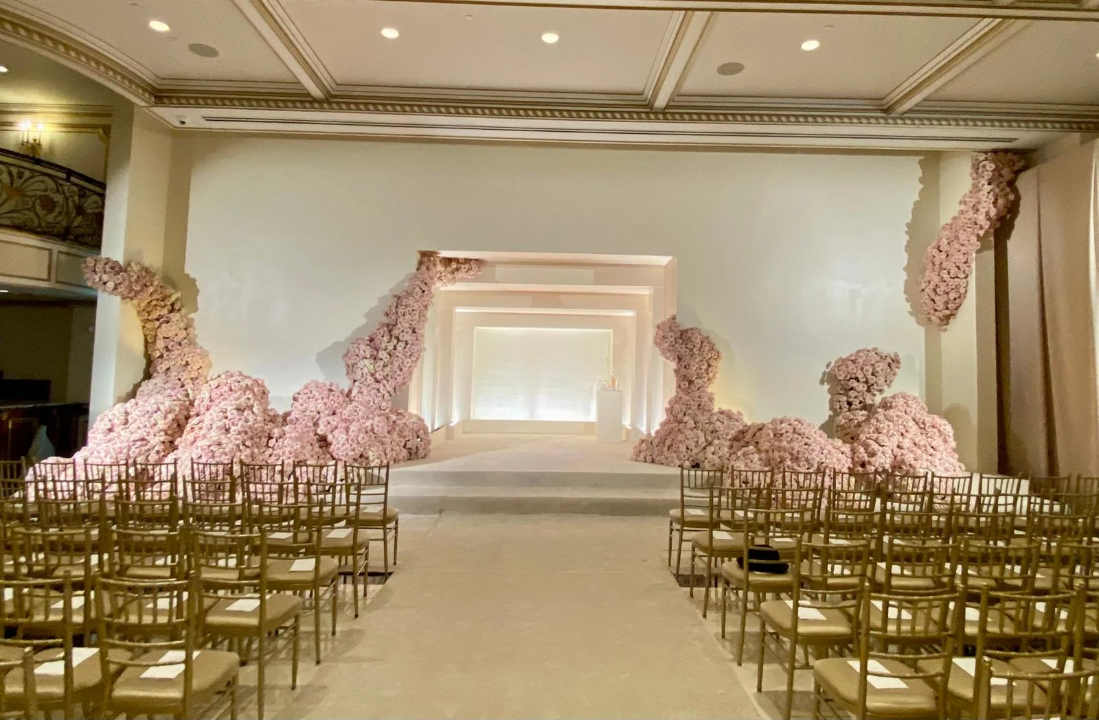 Cascading cherry blossom floral installation lining a reception corridor