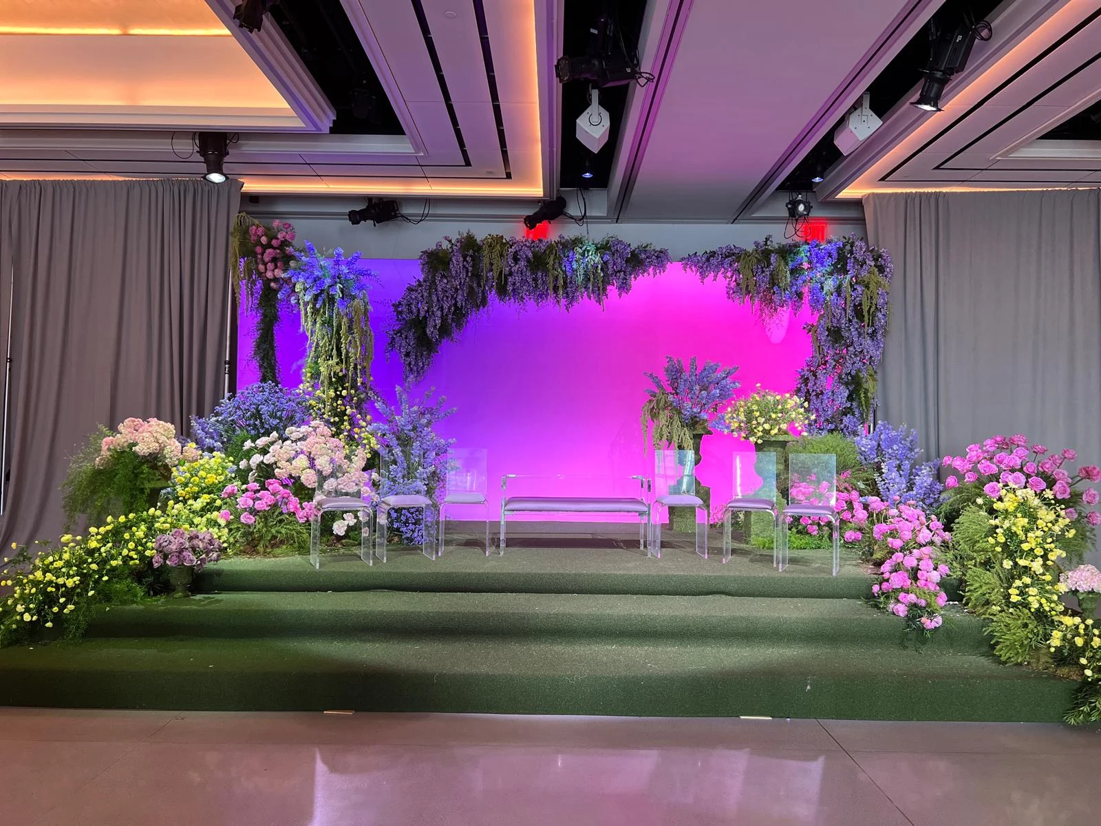 Custom-designed floral lounge stage with bespoke seating