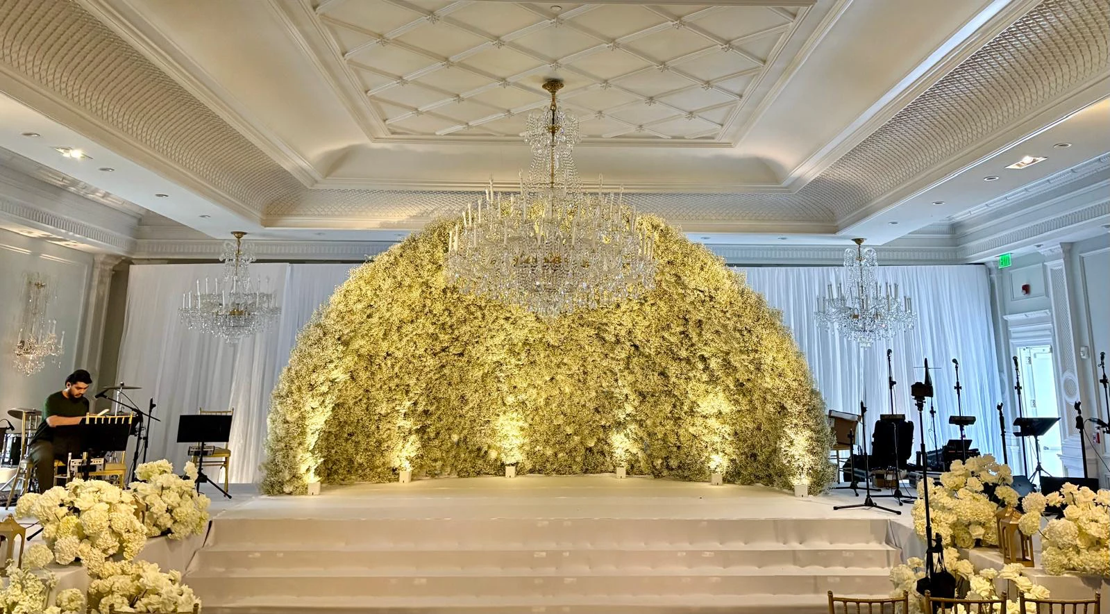 Grand floral dome stage installation with crystal chandelier